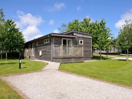 A cabin with a pathway and trees at 12 Meadow Retreat in Dobwalls