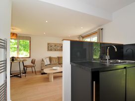 A kitchen with a sink and living area at 12 Meadow Retreat in Dobwalls
