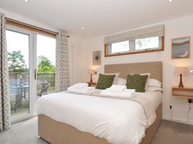 A bedroom with a bed and bedside tables at 12 Meadow Retreat in Dobwalls