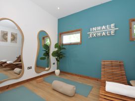 A yoga room with mirrors and wooden furniture at 12 Meadow Retreat in Dobwalls