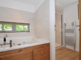 A bathroom with a bathtub and a shower at 12 Meadow Retreat in Dobwalls