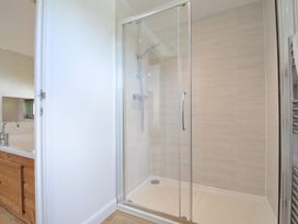 A bathroom featuring a shower and bathtub at 12 Meadow Retreat in Dobwalls
