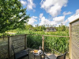 An outdoor seating area with a table and chairs at 12 Meadow Retreat in Dobwalls