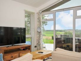 A living room with a television and coffee table at 8 Horizon View in Dobwalls