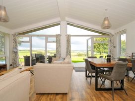 A living room with a dining area and sliding doors at 8 Horizon View in Dobwalls