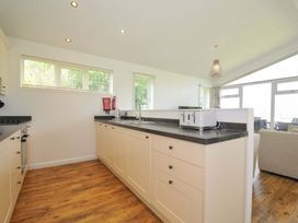 A kitchen with cabinets and appliances at 8 Horizon View in Dobwalls