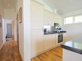 A kitchen with cabinets and appliances at 8 Horizon View in Dobwalls