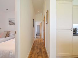 A hallway with a bed and kitchen cabinet at 8 Horizon View in Dobwalls
