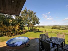 An outdoor area with a hot tub and a table with chairs at 8 Horizon View in Dobwalls