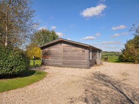 A wooden cabin surrounded by grass and trees at 8 Horizon View in Dobwalls