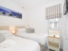 A bedroom with two beds and a window at 9 Horizon View in Dobwalls