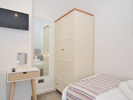 A bedroom with a wardrobe and television at 9 Horizon View Dobwalls