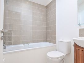 A bathroom with a bathtub, toilet, and sink at 9 Horizon View Dobwalls