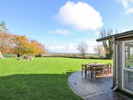 An outdoor seating area with a wooden table and chairs at 9 Horizon View in Dobwalls