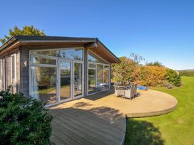 A house with a decking area and outdoor furniture at 10 Horizon View, Dobwalls