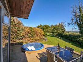 A garden with a hot tub and dining set at 10 Horizon View in Dobwalls
