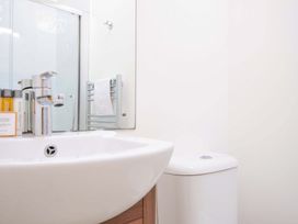 A bathroom with a sink, toilet, and towel rack at 10 Horizon View in Dobwalls
