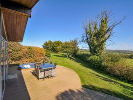 A deck with outdoor furniture and a hot tub at 10 Horizon View in Dobwalls