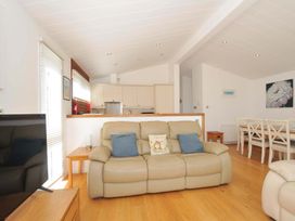 A living room with a sofa and a dining area at 11 Horizon View in Dobwalls