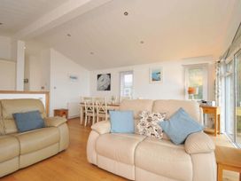 A living room with a sofa and dining table at 11 Horizon View Dobwalls