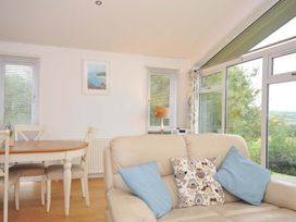 A living room with a sofa and dining table at 11 Horizon View in Dobwalls