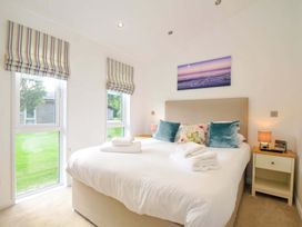 A bedroom with a bed and windows at 11 Horizon View in Dobwalls