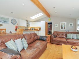 A living room with a sofa and dining area at 15 Horizon View, Dobwalls