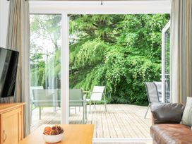 A living room with a view of a deck and greenery at 15 Horizon View Dobwalls