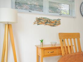 A wooden table with a bowl and plant in a dining room at 15 Horizon View in Dobwalls