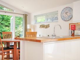 A kitchen with a sink and dining table at 15 Horizon View in Dobwalls