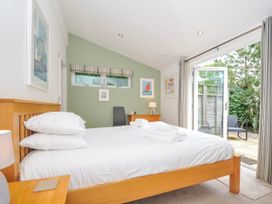 A bedroom with a bed and access to outdoor space at 15 Horizon View Dobwalls