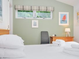 A bedroom with a bed, chair, and drawer at 15 Horizon View in Dobwalls
