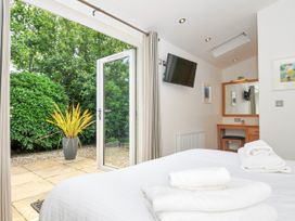 A bedroom with a bed and a view of the garden at 15 Horizon View in Dobwalls