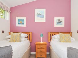 A bedroom with two single beds and artworks on the wall at 15 Horizon View in Dobwalls
