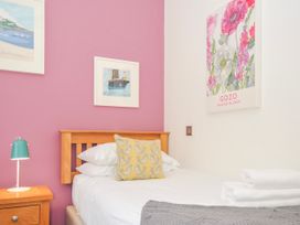 A bedroom with a bed, decorative cushion, and wall art at 15 Horizon View in Dobwalls