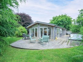 A garden with a wooden deck and chairs at 15 Horizon View in Dobwalls