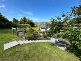 A garden with steps leading to a table at Delfryn, Newport