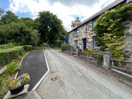 A house with a stone wall and garden at Delfryn, Newport