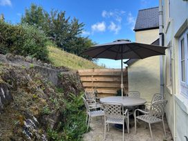 An outdoor seating area with a table and chairs at Delfryn, Newport