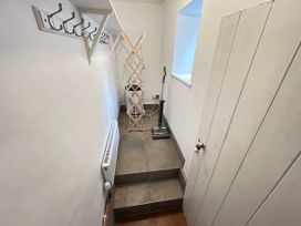 A hallway with hooks and a clothes dryer at Delfryn, Newport in Newport, Pembrokeshire
