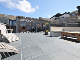 A patio area with outdoor furniture and a pergola at Breakers View in Polzeath