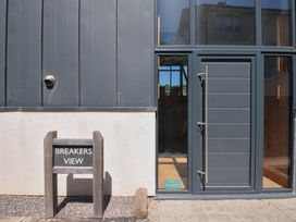 An exterior view of Breakers View with a sign at Polzeath