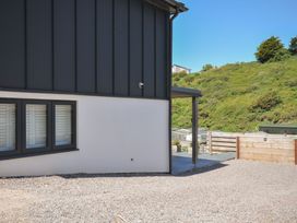 An outdoor area with gravel, windows, and a fence at Breakers View in Polzeath