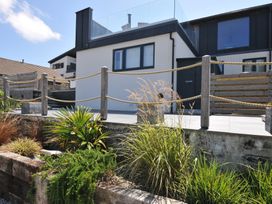 An outdoor area with a house, balcony, and plants at Breakers View in Polzeath