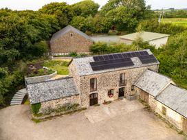 An outdoor view of a barn with solar panels at Hoppers Barn in Pancrasweek near Holsworthy