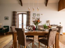 A dining room with a table and chairs at Hoppers Barn Pancrasweek near Holsworthy