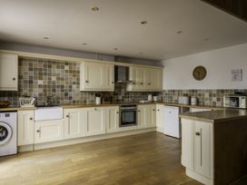 A kitchen with cabinets and appliances at Hoppers Barn in Pancrasweek near Holsworthy