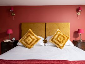 A bedroom with a bed and bedside tables at Hoppers Barn Pancrasweek near Holsworthy