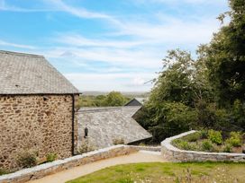 A view of stone buildings and a garden at Hoppers Barn Pancrasweek near Holsworthy