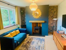 A living room with a fireplace and sofa at Hillsview in Combe Martin